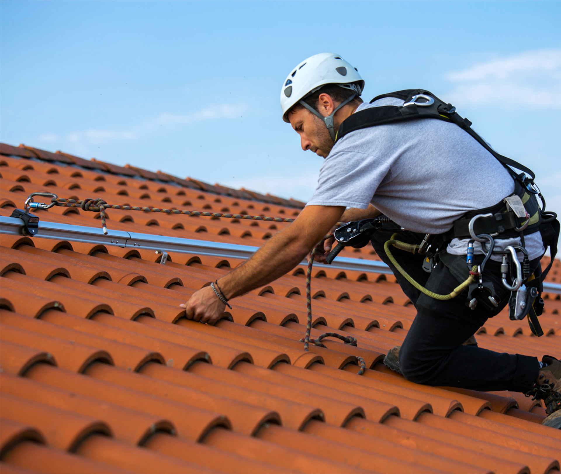 Homme travaillant sur un toit, équipé de protections individuelles